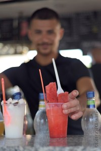 Un cosiddetto "gratachecaro" porge due bicchieri di grattachecca